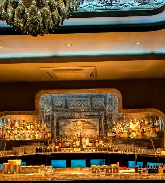 The ornate back-bar and chandelier inside Dupion Cocktail Room